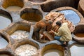 FEZ, MOROCCO Ã¢â¬â APRIL 10, 2016: The incredible historical tannery in Fez, Morocco. Workers painting leather in Morocco, Africa o